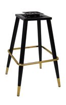 Black metal frame with gold footrest and feet